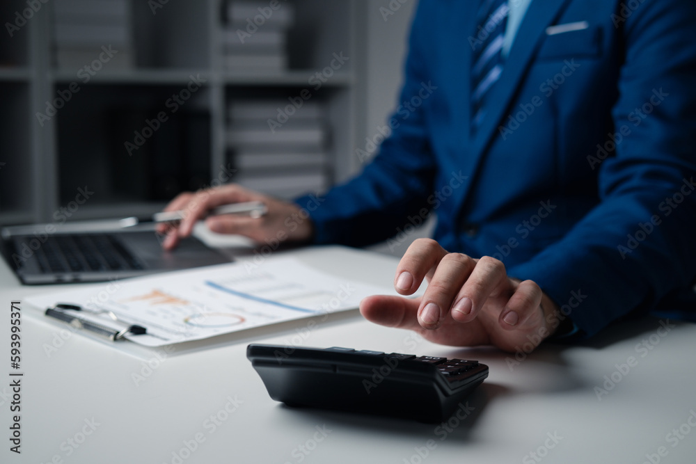 Close up businessman hand using calculator and working with laptop calculate about finance accounting. Close up businessman hand using calculator and working with laptop calculate about finance accounting.