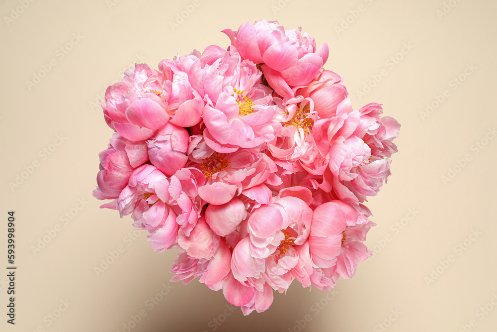 Bunch of beautiful peonies on beige background, top view Bunch of beautiful peonies on beige background, top view