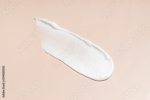 White cosmetic cream texture, skincare lotion swatch on pastel background. Face creme, body moisturiser, hair conditioner smear smudge stroke. Creamy beauty product closeup