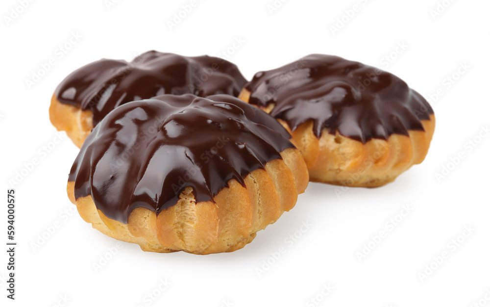Delicious profiteroles with chocolate spread isolated on white Delicious profiteroles with chocolate spread isolated on white