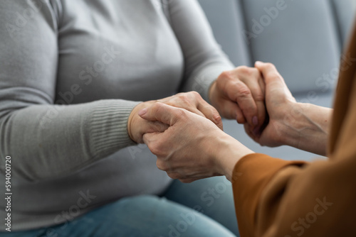 Closeup of a support hands. Closeup shot of a young woman holding a senior woman's hands in comfort. Female carer holding hands of senior woman