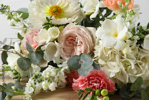 Bouquet of beautiful flowers on wooden table  closeup