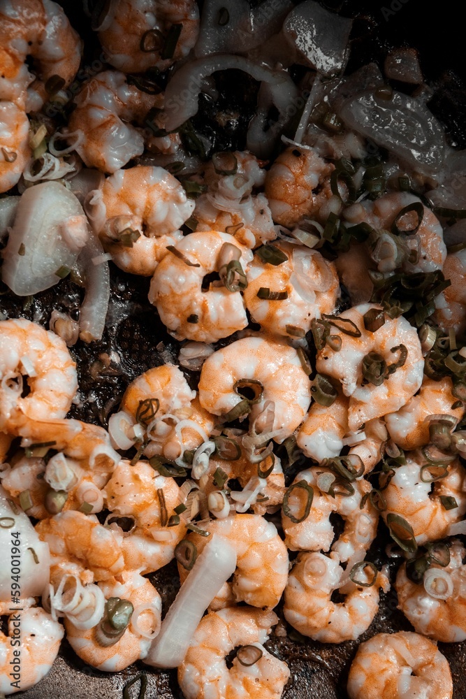 Close-up, vertical shot of a meal featuring cooked shrimps Close-up, vertical shot of a meal featuring cooked shrimps