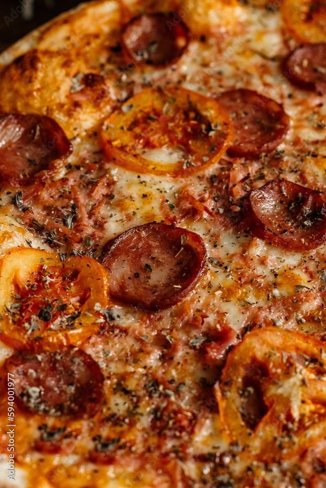 a pizza topped with pepperoni and cheese sitting on a plate a pizza topped with pepperoni and cheese sitting on a plate
