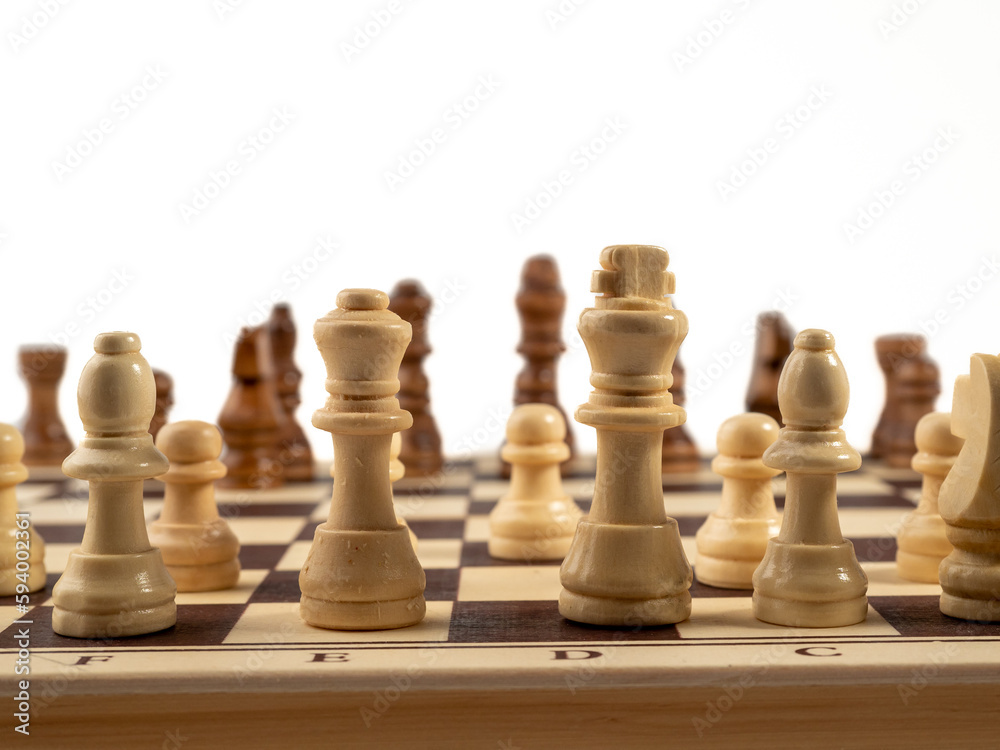 Wooden chess on a white background. Board game chess. Close-up. Wooden chess on a white background. Board game chess. Close-up.