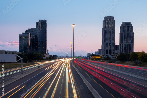 Speed traffic  light trails on freeway at night  long exposure abstract urban background. Toronto West highway 427 southbound. High travel speed effect  dui  careless  dangerous  drunk driving concept