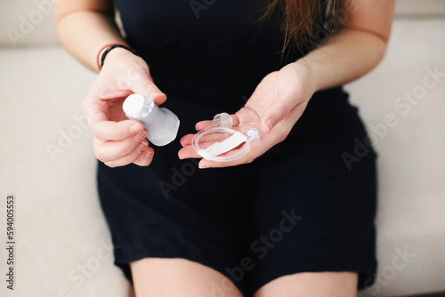 Female hands unpacking a new infusion set