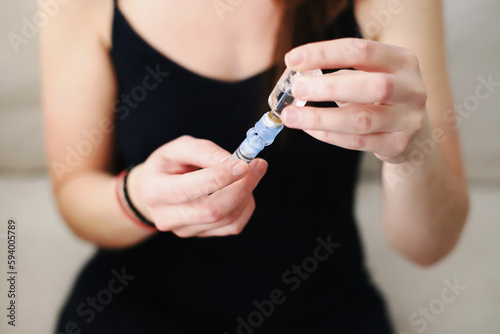 Woman filling up the reservoir of her insulin pump with insulin