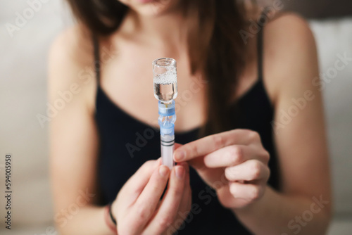 Woman filling up the reservoir of her insulin pump with insulin