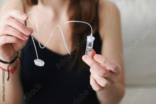Woman, Holding, Reservoir, Filled with insulin, Insulin pump, Type 1 diabetes, Diabetes care, Medical equipment, Diabetes supplies, Health care,