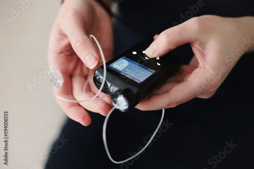 Woman holding her insulin pump in hands