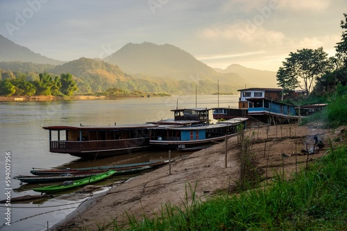 High angle shot of boats moored onto the pier of Mekong River in Luang Prabang, Laos