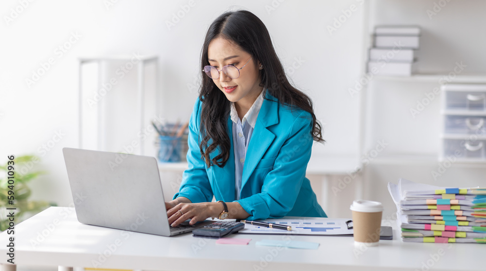 Asian Business woman using calculator and laptop for doing math finance on an office desk, tax, report, accounting, statistics, and analytical research concept
Asian Business woman using calculator and laptop for doing math finance on an office desk, tax, report, accounting, statistics, and analytical research concept