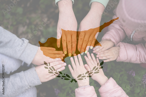 Hands of kids on background of Cyprus flag. Cypriot patriotism and unity concept.