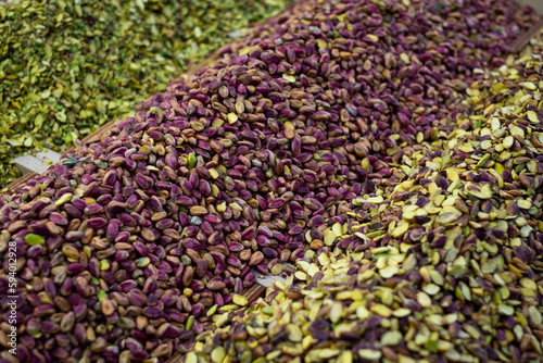 Piles of pistachio nuts for sale on food market photo