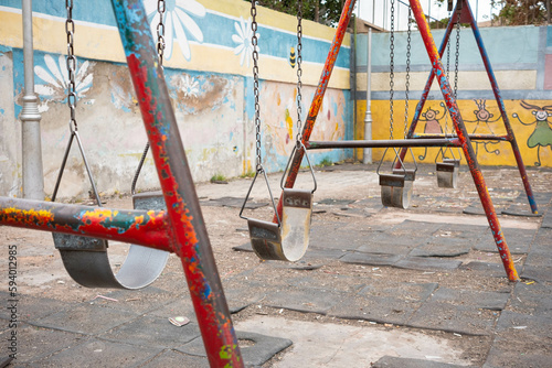 run down swing on old children`s  playground photo