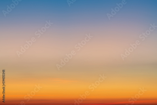 Fototapeta Naklejka Na Ścianę i Meble -  The dramatic colors of the sunset in the sky gradient from blue to orange.