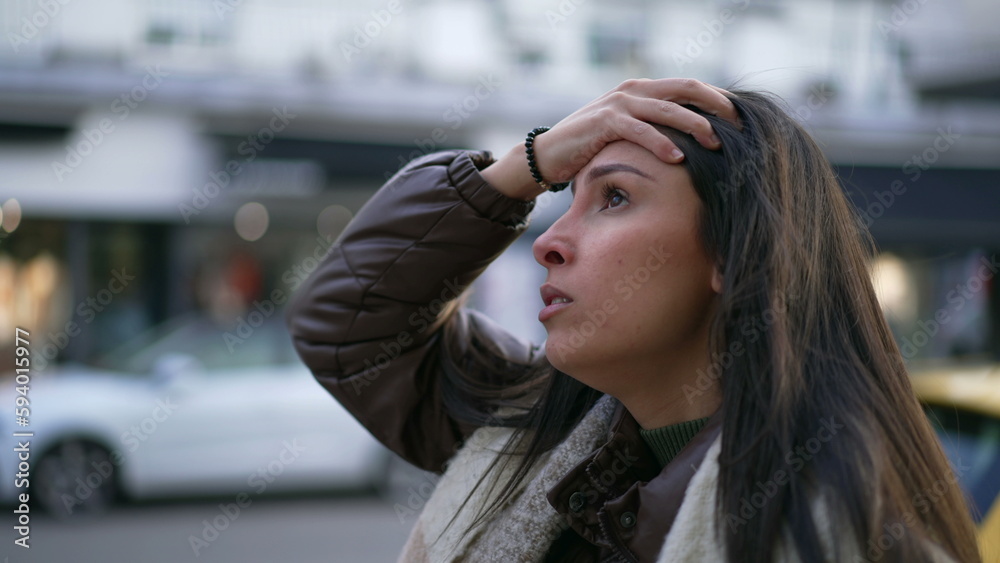 One anxious Middle Eastern young woman walking in street feeling frustrated. Female person in 20s suffering from mental pressure in urban environment sidewalk One anxious Middle Eastern young woman walking in street feeling frustrated. Female person in 20s suffering from mental pressure in urban environment sidewalk