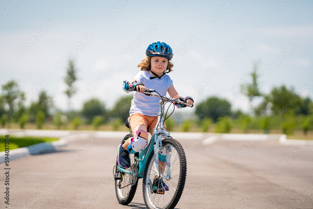 Child in safety helmet riding bike. Boy riding bike wearing a helmet outside. Child in safety helmet riding bike. Little kid boy learns to ride a bike. Kid on bicycle. Happy child in helmet riding a Child in safety helmet riding bike. Boy riding bike wearing a helmet outside. Child in safety helmet riding bike. Little kid boy learns to ride a bike. Kid on bicycle. Happy child in helmet riding a