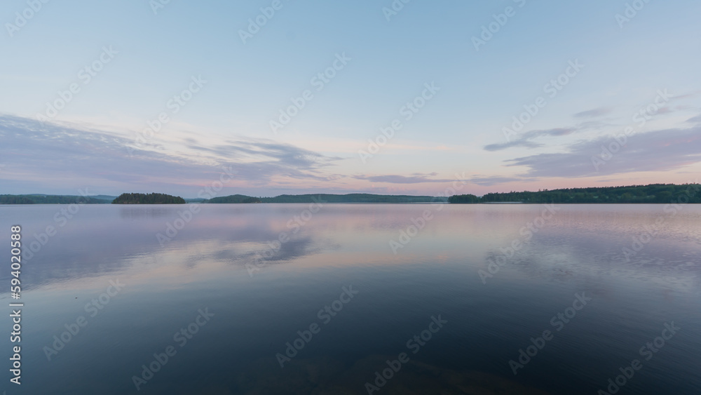 Summer lake scenery with clouds reflected on the water in Finland