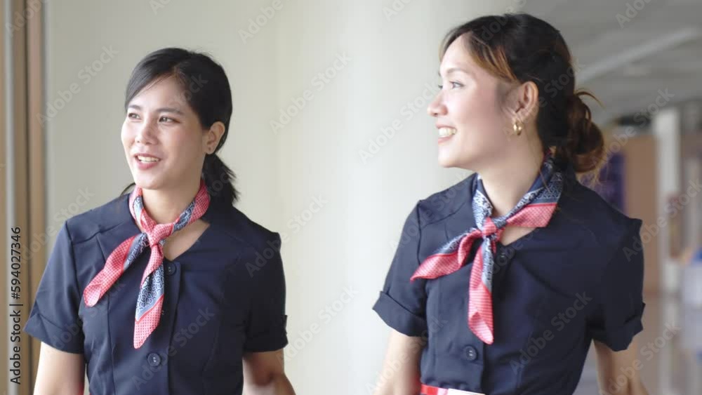 Beautiful asian cabin crew women talking with collegue at airport, Job and occupation airline workers concept. Beautiful asian cabin crew women talking with collegue at airport, Job and occupation airline workers concept.