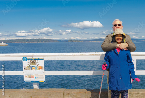 Septuagenarian couple enjoying a walk together at Sydney, BC, waterfront.
