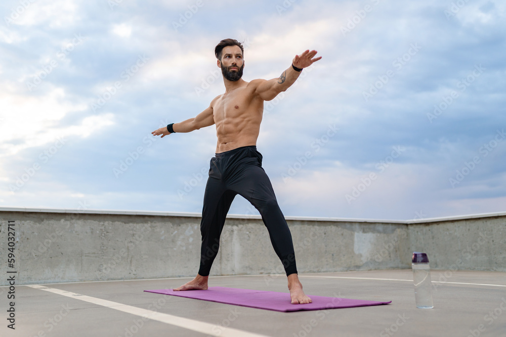 Fototapeta premium attractive hansome man with athletic strong body doing morning yoga asana outdoors