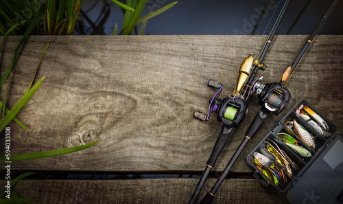 Fishing rods and reels on wooden background. Tools for fishing.