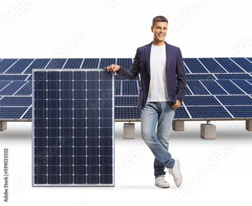 Casual man leaning on a solar panel and smiling photo