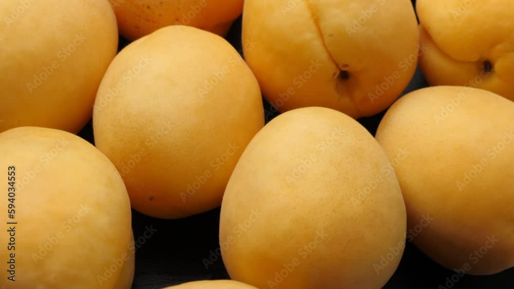 A lot of orange and ripe apricots fruits rotating, closeup A lot of orange and ripe apricots fruits rotating, closeup