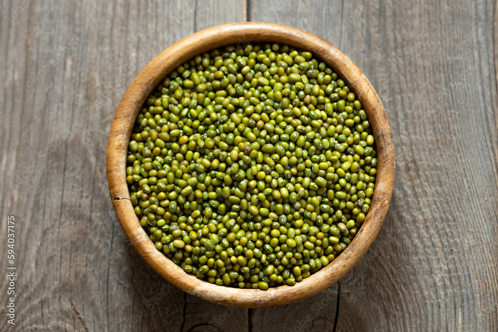 Bowl of fresh mung beans (Vigna radiata) on an old wooden table Bowl of fresh mung beans (Vigna radiata) on an old wooden table
