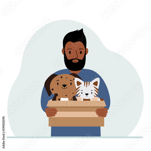 A man holds a cardboard box with a cat and a dog. The concept of rescue, help and care for pets.