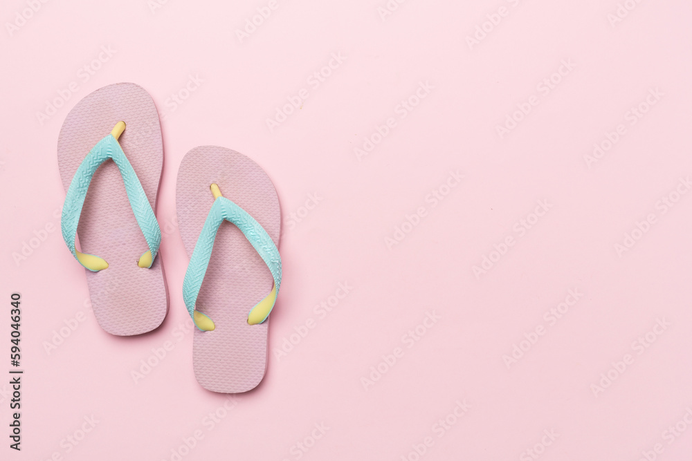 Bright flip flops on color background, top view