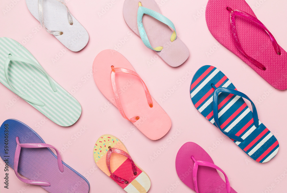 Many bright flip flops on color background, top view Many bright flip flops on color background, top view