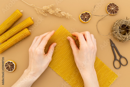 DIY - do it yourself concept. Hands making beeswax honey aroma candles photo