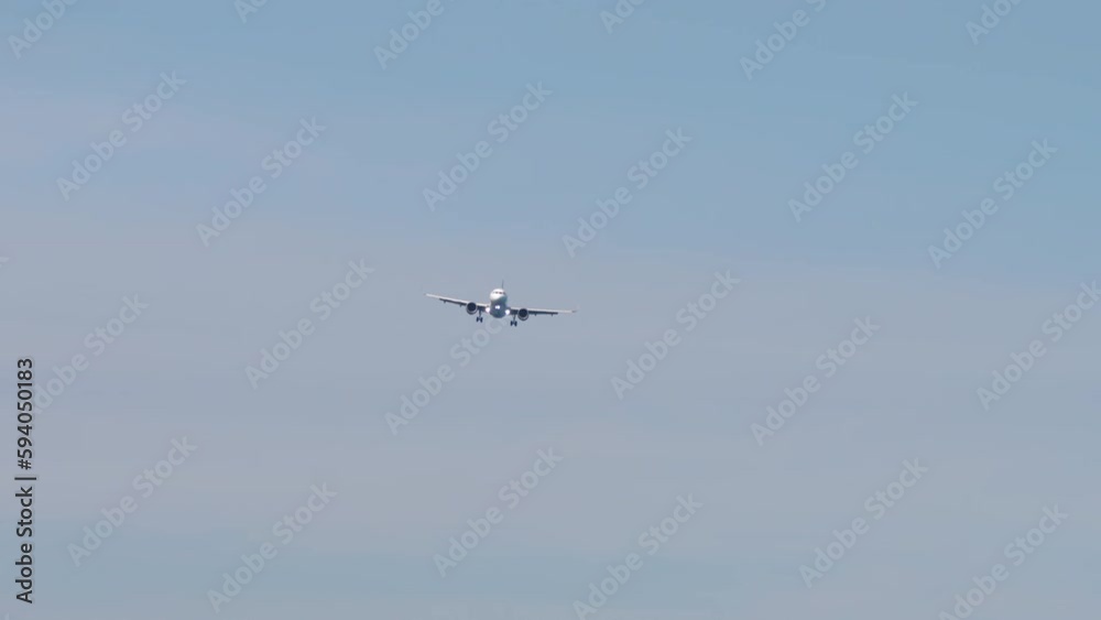 Plane approaching landing. Long shot of aircraft descending. Airplane high in the sky. Tourism and travel concept Plane approaching landing. Long shot of aircraft descending. Airplane high in the sky. Tourism and travel concept