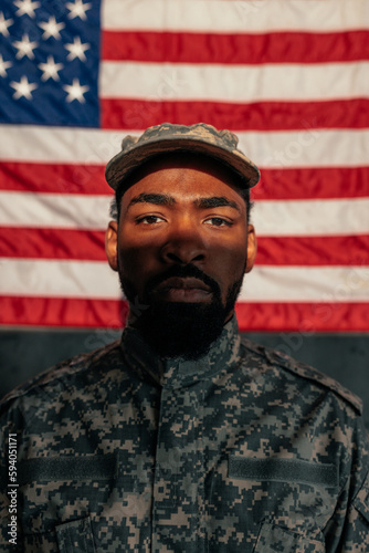 Young adult African American soldier with American flag.