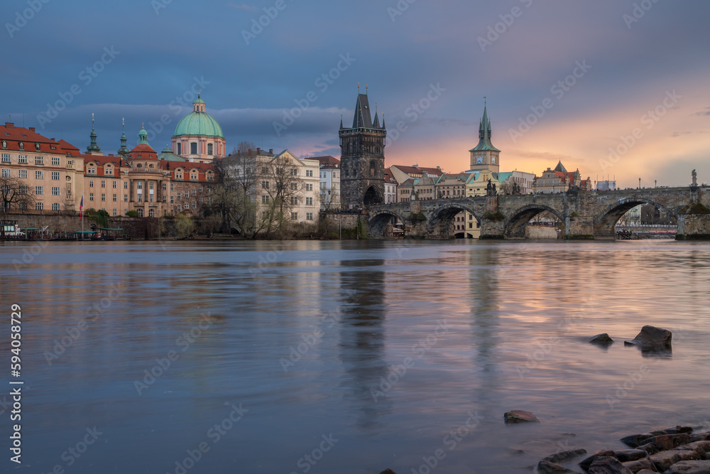 View of Prague's Old Town and Charles Bridge from the river level at sunset