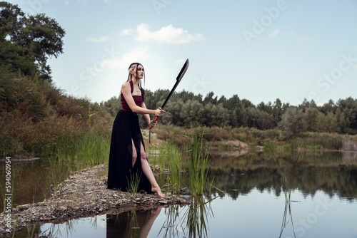 Caucasian woman holding knife and standing near lake