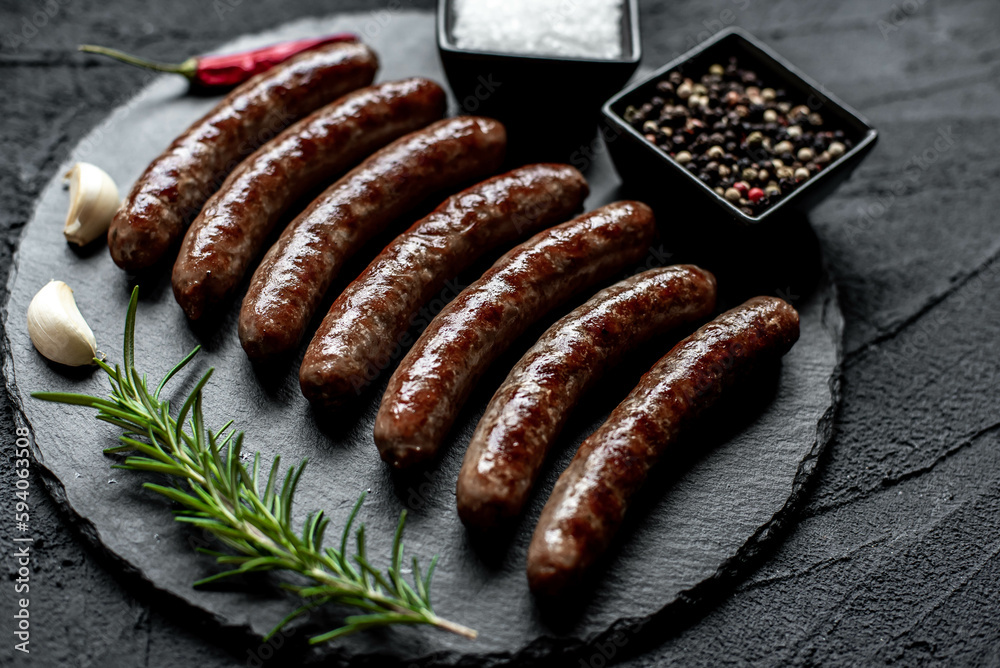 grilled beef sausages on stone background 
