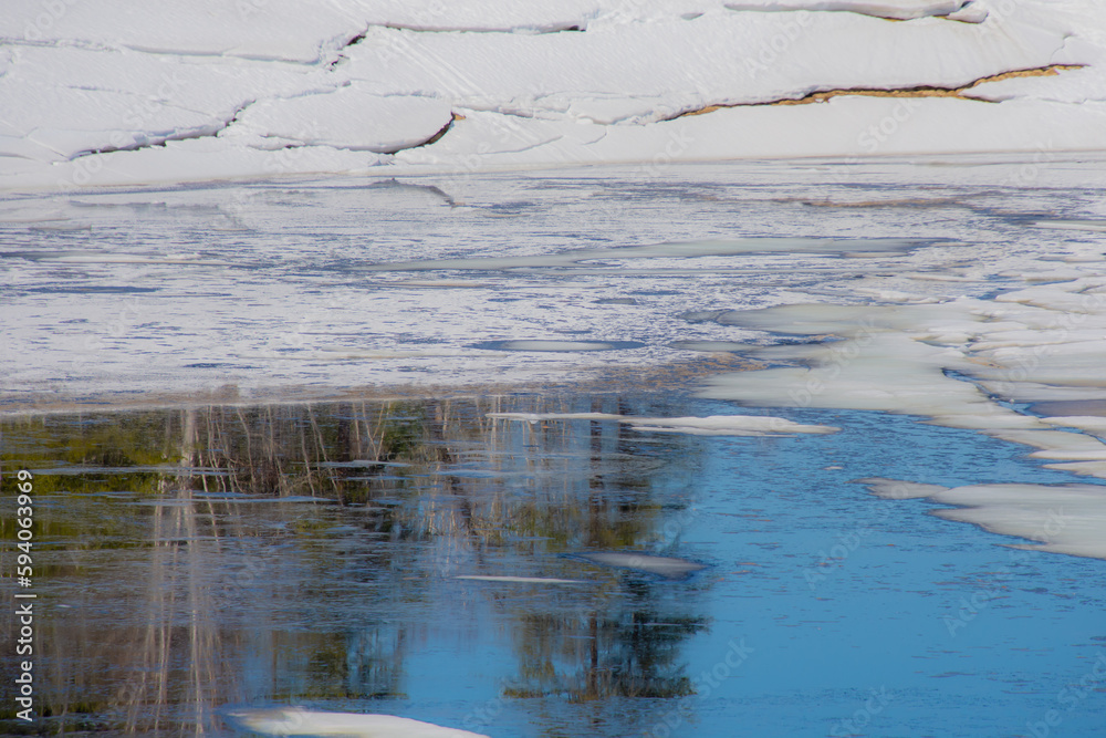 Melting ice in the spring on a lake in the Canadian forest in Quebec Melting ice in the spring on a lake in the Canadian forest in Quebec
