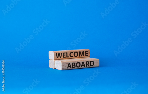 Welcome aboard symbol. Concept word Welcome aboard on wooden blocks. Beautiful blue background. Business and Welcome aboard concept. Copy space