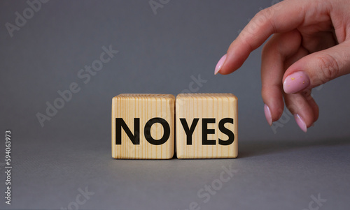 Yes vs No symbol. Businessman hand is making a choice between YES and No symbol. Beautiful grey background. Business concept. Copy space.