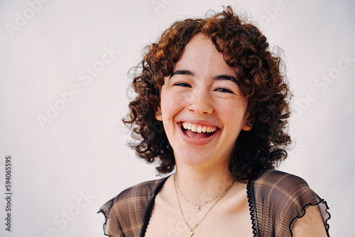 portrait of young adult millennial with perfect toothy smile laughing looking at camera
