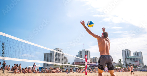  Active summer sport near the sea, beach volleyball against the backdrop of city buildings. Close-up. Generative Ai content.