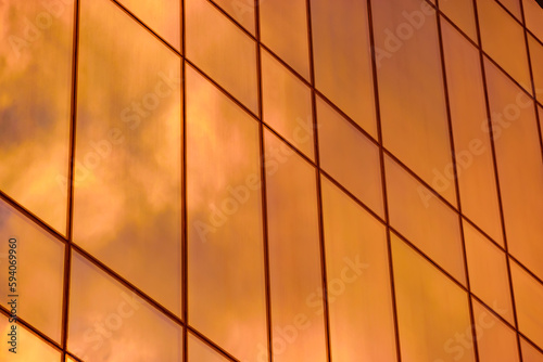 sunset reflection in the windows of the building. part of the building