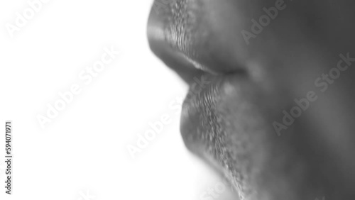 Black and white video of woman's mouth talking or singing. Artistic. Macro.