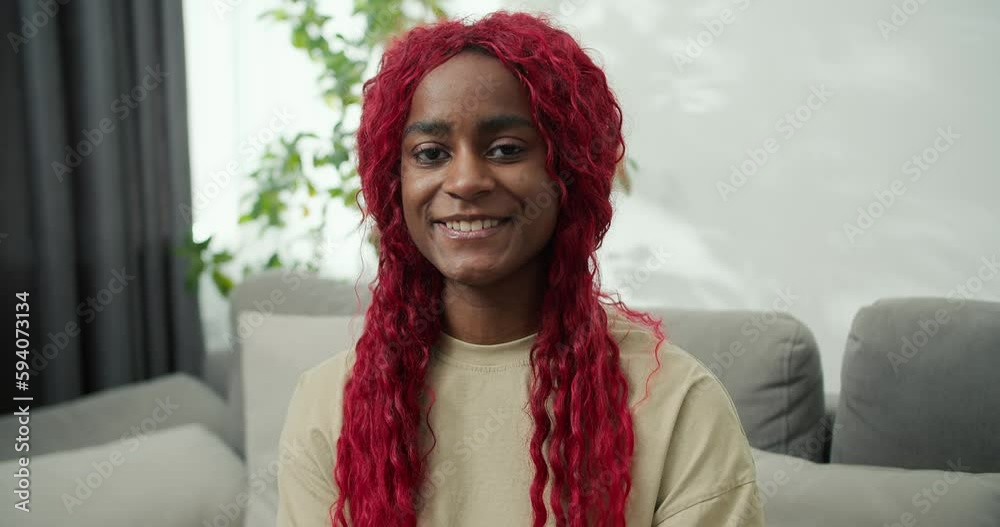 Portrait of smiling African american woman with red stylish hair at home Portrait of smiling African american woman with red stylish hair at home