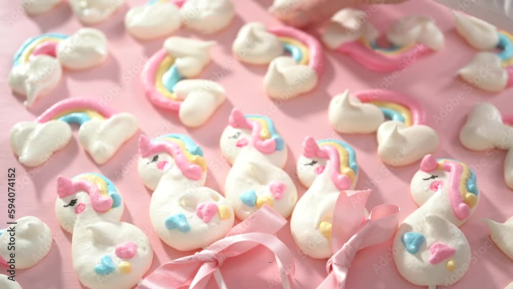 Step by step. Holding close to the camera, the unicorn meringue pops cookies. Step by step. Holding close to the camera, the unicorn meringue pops cookies.