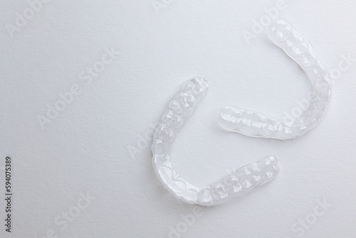 Aligners for straightening teeth on a light background.